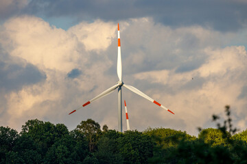 Wind turbine against a cloudly blue sky