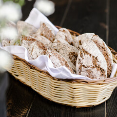 Small rye bread loafs in a basket at a restaurant