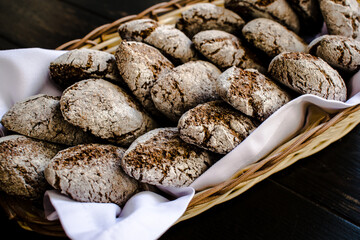 Small rye bread loafs in a basket at a restaurant