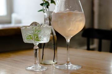 Gin cocktails on a wooden table in a restaurant near window