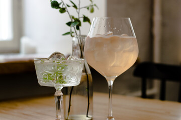 Gin cocktails on a wooden table in a restaurant near window