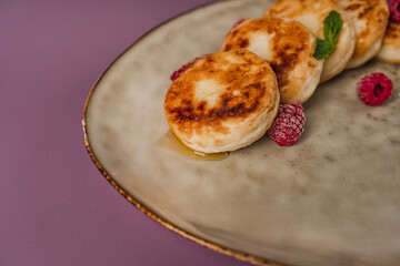 Healthy breakfast, cheese pancakes with raspberry and mint,  copy space