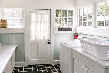 A vintage laundry room filled with windows and natural light