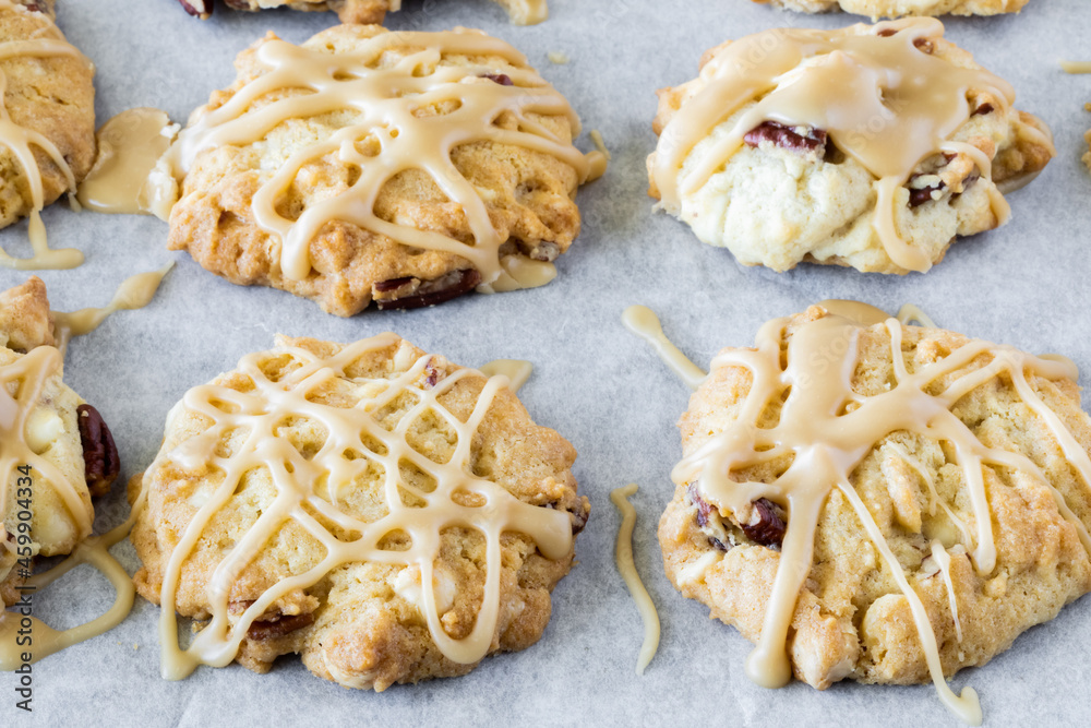 Wall mural close up view of maple pecan cookies with maple icing drizzled on top.