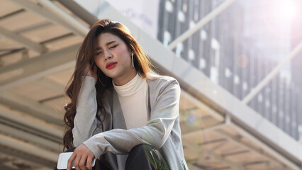 Lay off. Sacked. Fired business woman sitting on stairs of office building outside. Depressed young business woman unemployment due to coronavirus crisis. worry no job no money. Laid off got fired. 