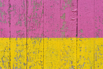 Colourful distressed wooden texture background painted pink and yellow