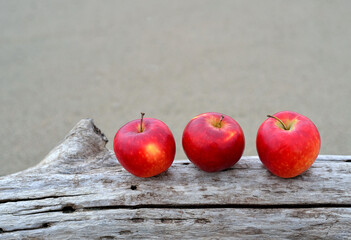 three red apples on a wooden table Thanksgiving Day