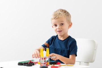 a little boy collects a children's designer from metal