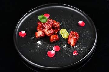 Sweet and sour pork ribs beautifully placed on a plate.