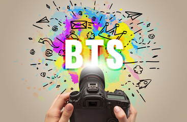 Close-up of a hand holding digital camera with abstract drawing