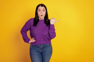 Portrait of stylish nice charming attractive cheerful magnificent adorable caucasian girl pointing , isolated over grey background