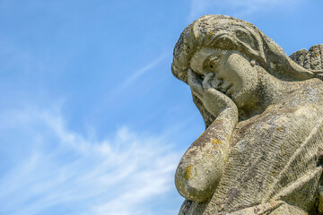 A very sad angel in a stone in the cemetery