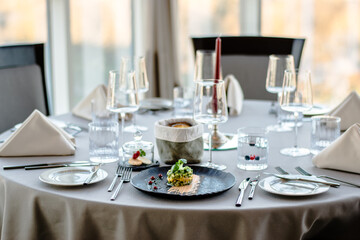 Colorful avocado tartar on a black plate at a restaurant