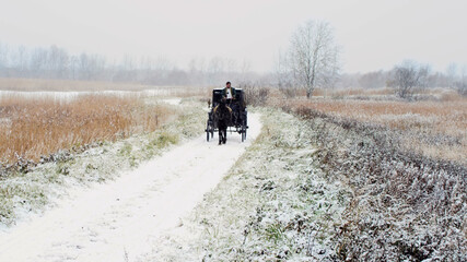 Man riding one horse carriage on winter road
