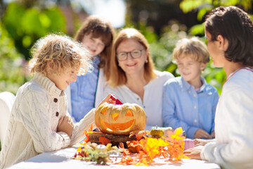 Family carving pumpkin for Halloween