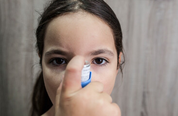 Child girl using medical spray for breath