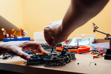 Man Repair A Drone.Engineer repairs a drone at home