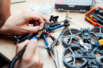 Man Repair A Drone.Engineer repairs a drone at home
