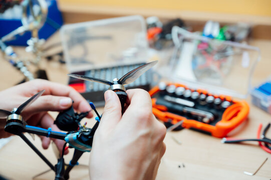 Man Repair A Drone.Engineer repairs a drone at home