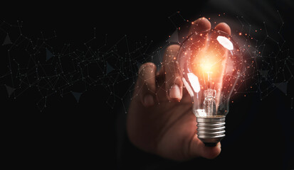 Businessman holding lightbulb glowing with connection line for creative thinking ideas and innovation concept.