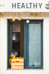 Split, Croatia  A window to a cafe kitchen with a box of citrus fruit and sign saying Healthy.