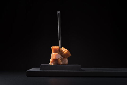 Gourmet quince jelly paste in ceramic plate on black background