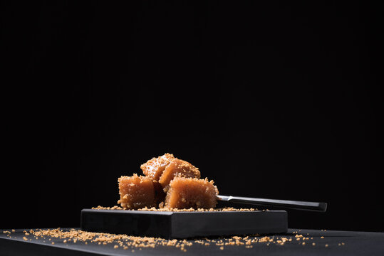 Gourmet quince jelly paste in ceramic plate on black background