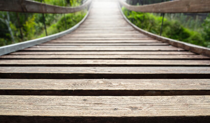 wooden bridge in the forest,  Pedestrian wooden bridge with light in the distance. Close-up.