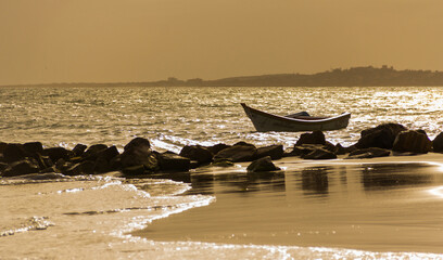 Boats at sea, backlit, at sunset time