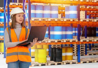 Warehouse manager. Chemical enterprise warehouse. Logistics center employee. Blue barrels represent...