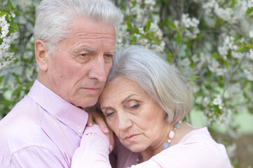 Sad Elderly couple together in park
