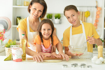 Portrait of happy family baking together in the kitchen