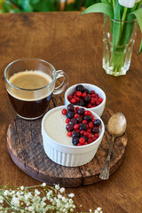 Panna cotta with berries. Wooden background. Side view.
