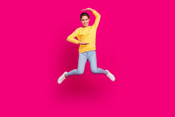 Fototapeta na wymiar Full length body size view of attractive cheerful girl jumping showing size isolated over bright pink color background