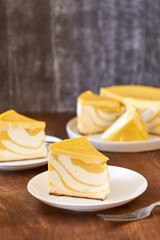 Pumpkin cheesecake. Striped cottage cheese casserole with pumpkin. Side view, wooden background.