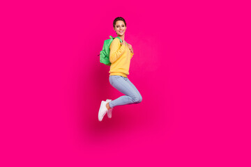 Fototapeta na wymiar Full length body size profile side view of pretty cheerful girl jumping with bag traveler isolated over bright pink color background