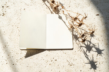 Autumn or winter wedding. Birthday stationery composition.Blank open diary with dry floral element....