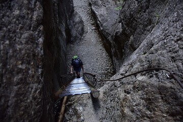 woman climbs a tourist ladder in a canyon. Slovakia Central Europe