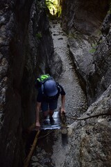 woman climbs a tourist ladder in a canyon. Slovakia Central Europe