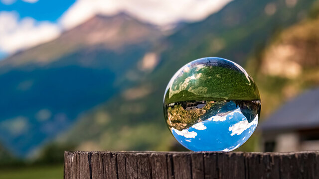 Crystal ball alpine landscape shot at the famous Fallbach waterfall, the highest waterfall in Kaernten, Maltatal, Austria