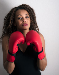 African American woman wearing red boxing gloves with attitude
