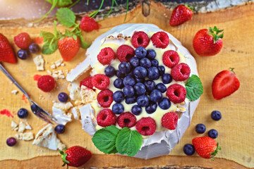 Delicious pavlova meringue with raspberries, strawberries and blueberries