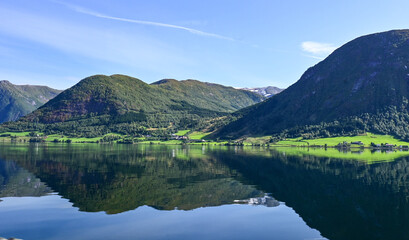 Reflection of mountains in a beautiful Norwegian fjord in summer