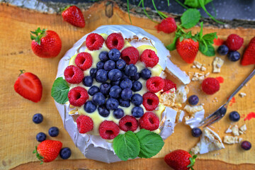 Delicious pavlova meringue with raspberries, strawberries and blueberries