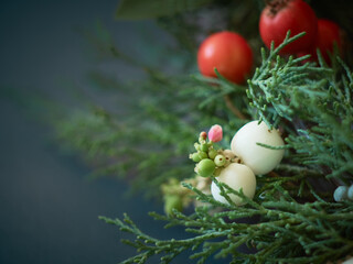 Details of Christmas wreath of fresh spruce, cones and сhristmas decorations, close up. New Year decorations.