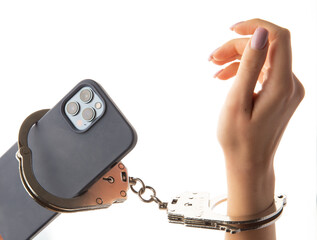 Hand handcuffed to the telephone on white background.