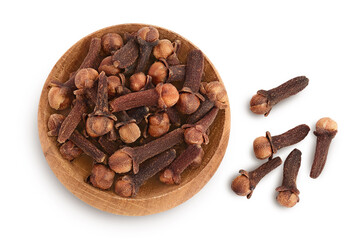 Dry spice cloves in wooden bowl isolated on white background with clipping path. Top view. Flat lay