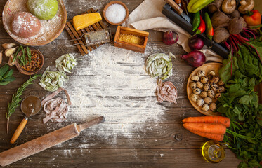 Ingredients for making pasta on a rustic background, top view. Flat lay. Italian recipe. Hand made. Process of making raw pasta. Manufacturing fresh italian pasta.