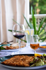food on the table red wine in a glass cognac in a glass