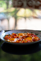 breakfast eggs with vegetables in a plate